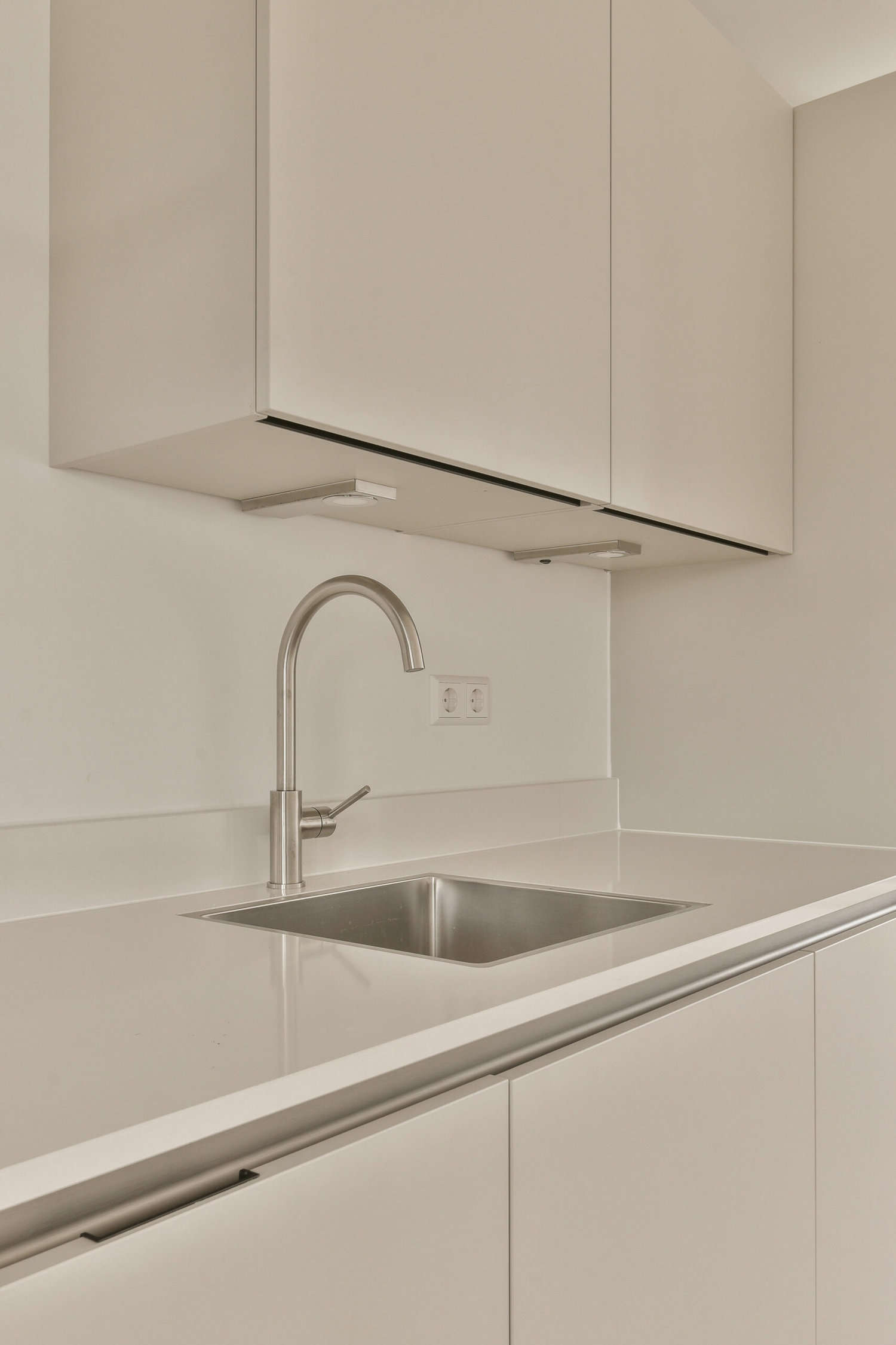 a kitchen with white cabinets and a sink