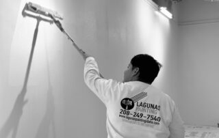 A painter painting the wall.