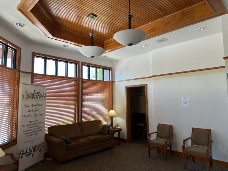 Office waiting room with wood-paneled ceiling, upholstered chairs, and large windows, commercial painting by Lagunas Painting in Boise, Idaho