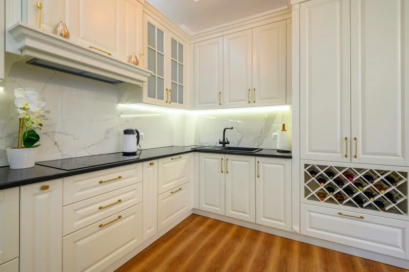 Modern bright white kitchen cabinets with sleek hardware and stainless steel appliances