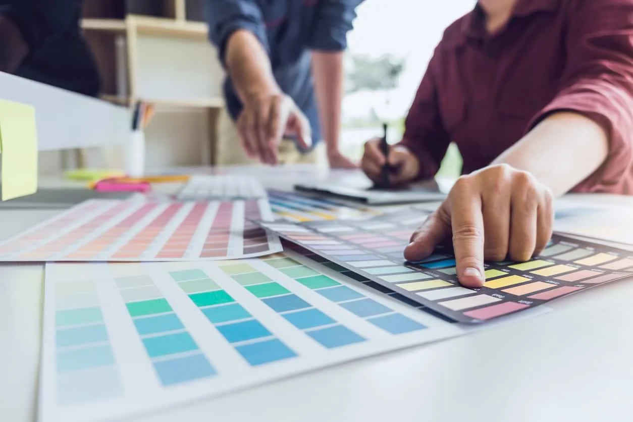 Color consultant reviewing paint swatch fan decks and color samples with a client, color consultation service by Lagunas Painting in the Treasure Valley, Idaho