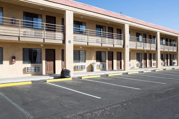 Freshly painted two-story commercial building exterior with balconies and a parking lot, commercial painting by Lagunas Painting in Nampa, Idaho