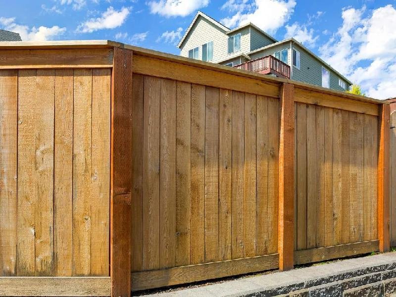Cedar wood privacy fence with a fresh natural stain finish at a home in the Treasure Valley, Idaho, by Lagunas Painting