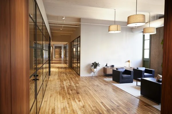 Modern commercial interior with wood floors and glass partitions painted by Lagunas Painting