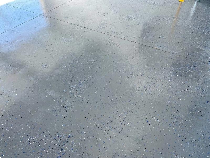 Gray industrial concrete floor coating with decorative flake finish installed by Lagunas Painting in the Treasure Valley, Idaho