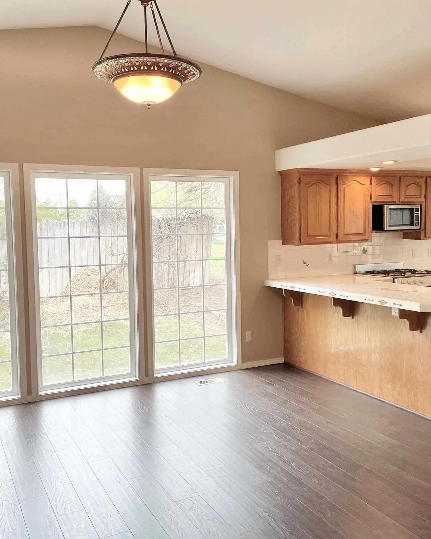 Bright breakfast nook with a pendant light and wood cabinets in a Boise, ID home painted by Lagunas Painting