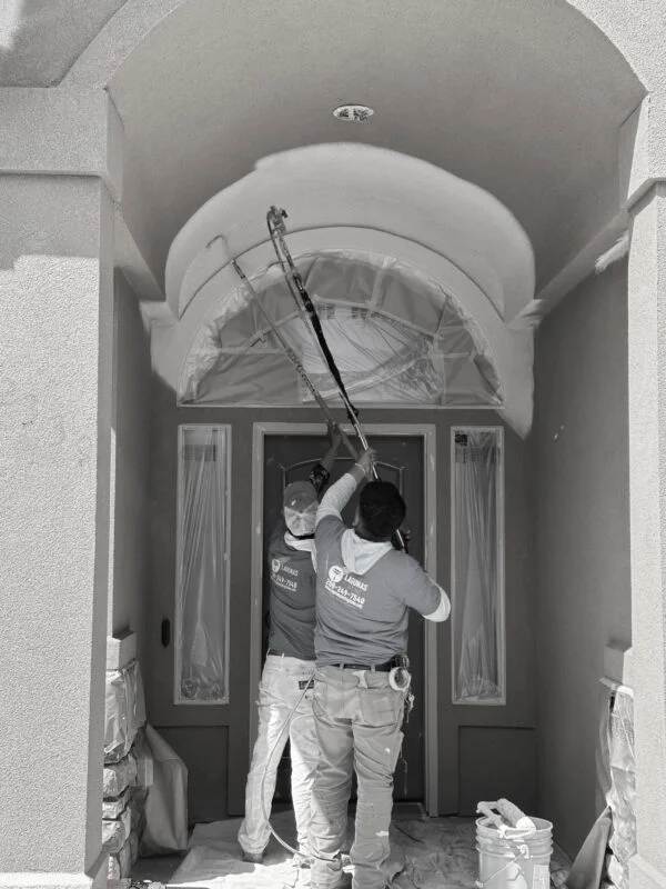 Lagunas Painting crew masking and painting an arched interior entryway in a Treasure Valley home in Caldwell, Idaho