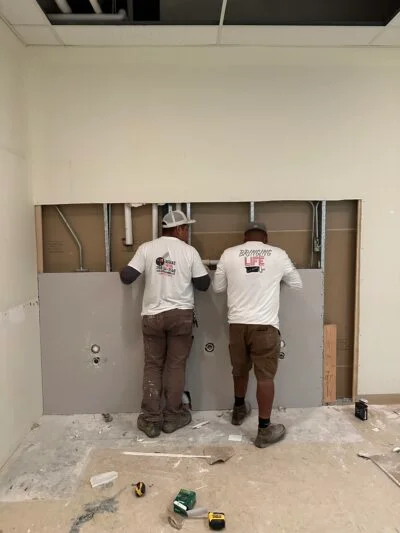 Two Lagunas Painting technicians working in a garage in the Treasure Valley, Idaho