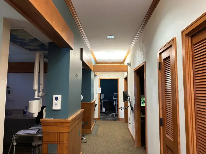Freshly painted interior hallway of a commercial office with wood trim and accent walls, interior commercial painting by Lagunas Painting in the Treasure Valley, Idaho