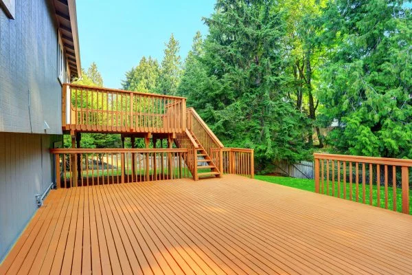 Freshly stained multi-level wooden deck with stairs and railings by Lagunas Painting